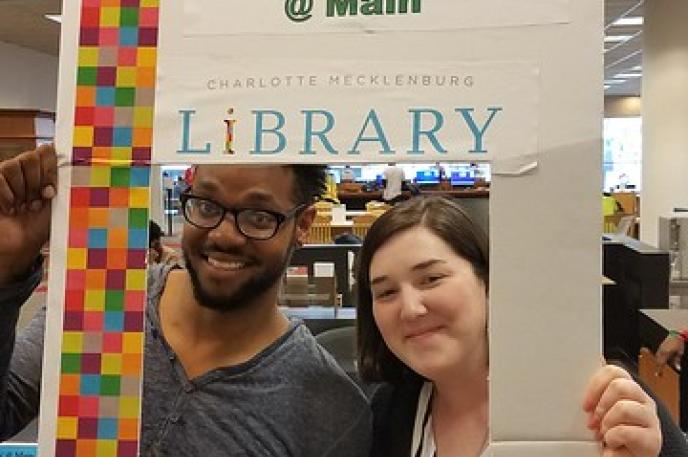 Staff member Jenna Marrotta and poet Sky pose together after she received her poem.