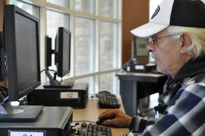 Man using computer at Charlotte Mecklenburg Library's Job Help Center.