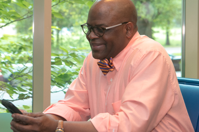 Man reading on his mobile device at Charlotte Mecklenburg Library.