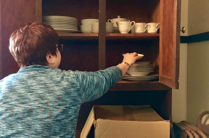 Shelia Bumgarner of Charlotte Mecklenburg Library's Robinson Spangler Carolina Room handles historic items at the Dowd House.