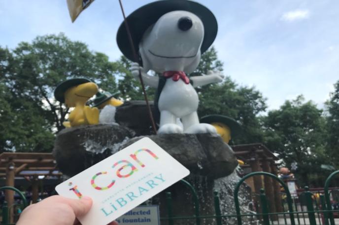 A Charlotte Mecklenburg Library cardholder takes their Library card on a Summer Break adventure to Carowinds Charlotte Mecklenburg Library is in its third week of Summer Break