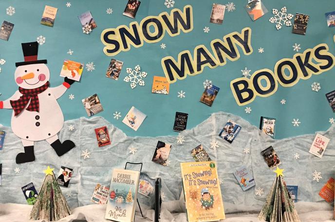 A holiday book display that reads "snow many books" at  Charlotte Mecklenburg Library's Mint Hill Library.