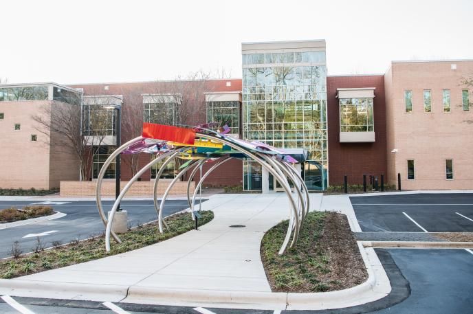 A front-entrance view of the newly renovated South County Regional Library branch with public art titled "Open Book, Open Mind" by Jim Gallucci.