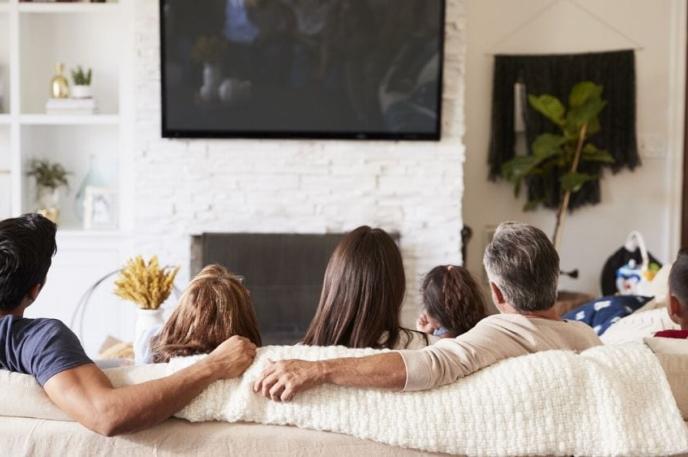 A family watches TV together. A family watches TV together.