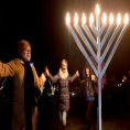 Photo of people dancing around a Hanukkah menorah courtesy of the Chicago Tribune